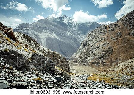Stock Photo - Daliz Pass, view of the ascent leading from Sarad-e-Broghil to the high valleys of the Wakhan Corridor, barren rocky landscape, in the background the mountains of the Hindu Kush, Wakhan Corridor, Badakhshan, Afghanistan, Asia. Fotosearch