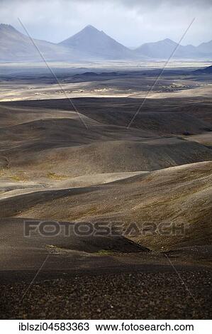 Stock Image - Desert-like, mountainous landscape with light and shadow, Moedrudalsfjalsfjallgardur, highlands, Island. Fotosearch