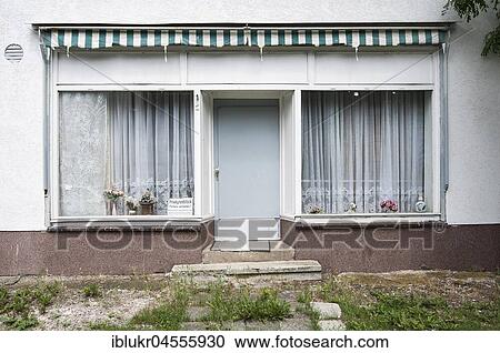 Stock Image - Dilapidated entrance with windows with old curtains, private house in Kassel, Hesse, Germany, Europe. Fotosearch