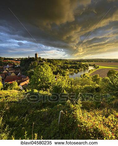 Dramatic atmosphere of clouds over Schönburg village and castle in the Saale Valley, Naumburg, Saxony-Anhalt, Germany, Europe View Large Photo Image Stock Photography - Dramatic atmosphere of clouds over Schönburg village and castle in the Saale Valley, Naumburg, Saxony-Anhalt, Germany, Europe. Fotosearch
