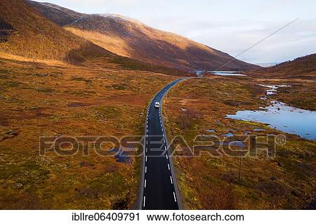Stock Image - Drone shot, campervan on a road with autumnal vegetation, Fylkesvei 862, Melfjordbotn, Senja, Norway, Europe. Fotosearch