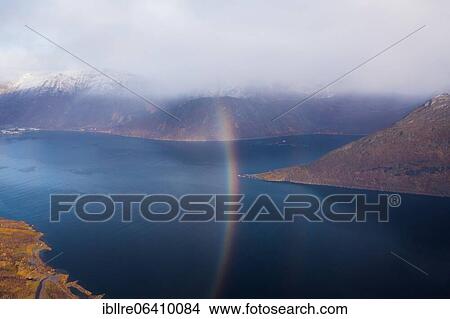 Picture - Drone shot, rainbow over the village of Fjordgård, Senja, Norway, Europe. Fotosearch
