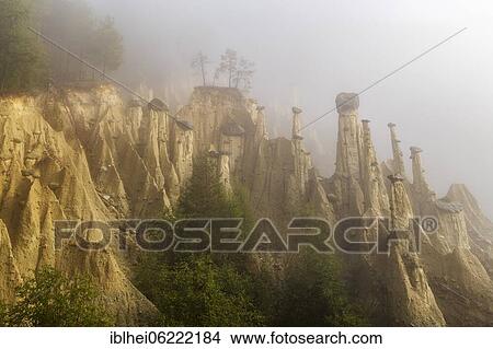 Picture - Earth pyramids near Perchau in the mist, South Tyrol, Italy, Europe. Fotosearch