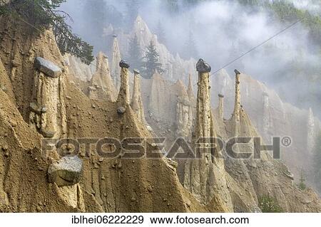 Stock Photo - Earth pyramids near Perchau in the mist, South Tyrol, Italy, Europe. Fotosearch