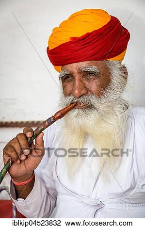Elderly Indian man with turban smoke hookah, Mehrangarh Fort, Jodhpur, Rajasthan, India, Asia View Large Photo Image Stock Image - Elderly Indian man with turban smoke hookah, Mehrangarh Fort, Jodhpur, Rajasthan, India, Asia. Fotosearch