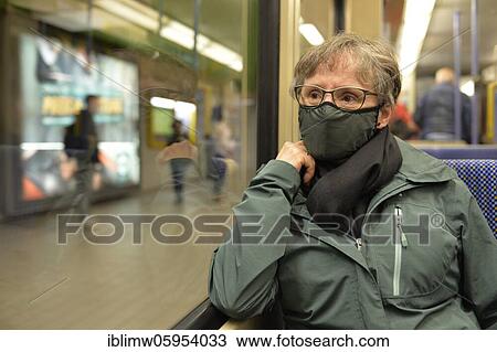 Stock Image - Elderly woman wearing a face mask, sitting in the subway, corona crisis, Stuttgart, Baden-Württemberg, Germany, Europe. Fotosearch
