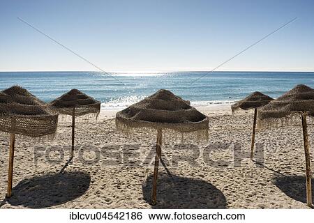 Stock Photograph - Empty beach with sunshades, Nerja, Andalusia, Costa del Sol, Spain, Europe. Fotosearch