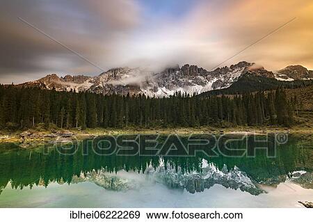 Evening mood at Lake Carezza, reflection of the Latemar in the water, South Tyrol, Italy, Europe View Large Photo Image Stock Photo - Evening mood at Lake Carezza, reflection of the Latemar in the water, South Tyrol, Italy, Europe. Fotosearch