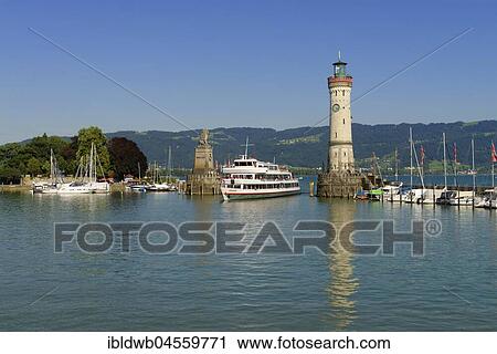 Excursion boat in the harbour entrance, between lighthouse and Bavarian lion, Lindau at Lake Constance, Swabia, Bavaria, Germany, Europe View Large Photo Image Stock Image - Excursion boat in the harbour entrance, between lighthouse and Bavarian lion, Lindau at Lake Constance, Swabia, Bavaria, Germany, Europe. Fotosearch