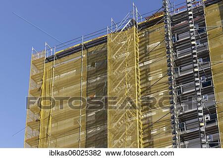 Facade with scaffolding and yellow cladding, building refurbishment, Düsseldorf, North Rhine-Westphalia, Germany, Europe View Large Photo Image Stock Image - Facade with scaffolding and yellow cladding, building refurbishment, Düsseldorf, North Rhine-Westphalia, Germany, Europe. Fotosearch