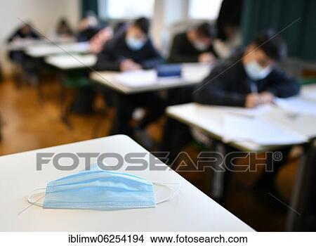 Face mask on school desk, classroom teaching, corona crisis, Stuttgart, Baden-Württemberg, Germany, Europe View Large Photo Image Picture - Face mask on school desk, classroom teaching, corona crisis, Stuttgart, Baden-Württemberg, Germany, Europe. Fotosearch