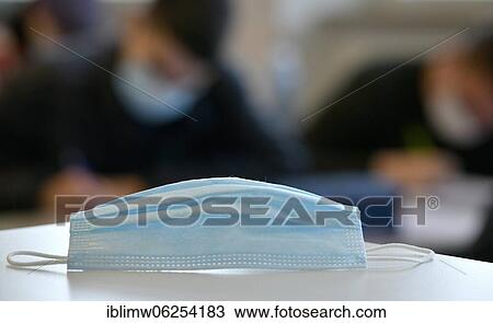 Stock Image - Face mask on school desk, classroom teaching, corona crisis, Stuttgart, Baden-Württemberg, Germany, Europe. Fotosearch