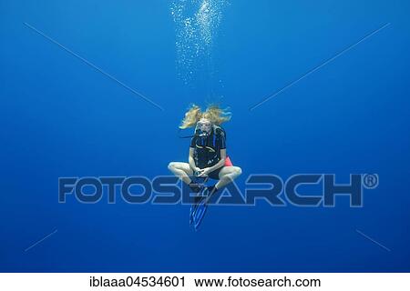 Female scuba diver hung in a lotus pose for a safety stop, in blue water, Indian Ocean, Maldives, Asia View Large Photo Image Stock Image - Female scuba diver hung in a lotus pose for a safety stop, in blue water, Indian Ocean, Maldives, Asia. Fotosearch