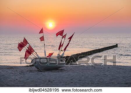 Stock Photography - Fishing boat on the beach at sunset, Ahrenshoop, Mecklenburg-Western Pomerania, Germany, Europe. Fotosearch