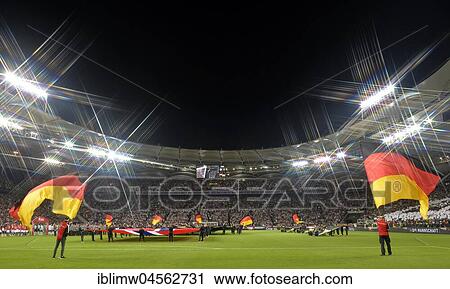 Flag waver with German flags in front of the start of the match, soccer stadium with floodlight in the evening, Mercedes-Benz Arena, Stuttgart, Baden-Württemberg, Germany, Europe View Large Photo Image Stock Image - Flag waver with German flags in front of the start of the match, soccer stadium with floodlight in the evening, Mercedes-Benz Arena, Stuttgart, Baden-Württemberg, Germany, Europe. Fotosearch
