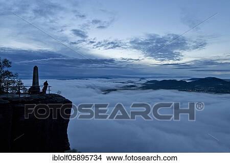 Fog in the Elbe Valley, Saxony, Germany, sunrise, twilight on the Lilienstein with a view into Saxon Switzerland on Papsstein and Gorisch, National Park Saxon Switzerland, Europe View Large Photo Image Picture - Fog in the Elbe Valley, Saxony, Germany, sunrise, twilight on the Lilienstein with a view into Saxon Switzerland on Papsstein and Gorisch, National Park Saxon Switzerland, Europe. Fotosearch