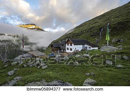Stock Photo - Furtschaglhaus with mountain peaks in the last sunlight and clouds, Berliner Höhenweg, Zillertal Alps, Zillertal, Tyrol, Austria, Europe. Fotosearch