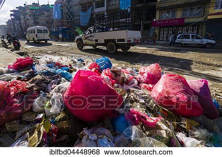 Stock Photo - Garbage piled up beside busy road in Bouda suburb, Kathmandu, Nepal, Asia. Fotosearch