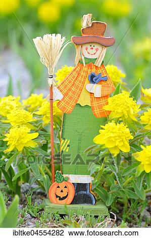 Stock Image - Garden decoration, manikin made of wood and bast. Fotosearch