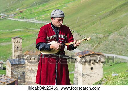 Georgian musician of a folkloric group playing Panduri, Ushguli, Svaneti region, Georgia, Asia View Large Photo Image Stock Photography - Georgian musician of a folkloric group playing Panduri, Ushguli, Svaneti region, Georgia, Asia. Fotosearch