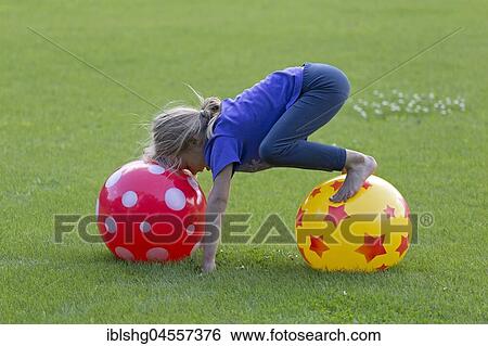 Girl makes tricks with balls, Germany, Europe View Large Photo Image Stock Photograph - Girl makes tricks with balls, Germany, Europe. Fotosearch
