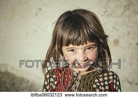 Girl with short cut pony, she has her chain in her mouth, Ishkashim, Afghanistan, Asia View Large Photo Image Stock Image - Girl with short cut pony, she has her chain in her mouth, Ishkashim, Afghanistan, Asia. Fotosearch