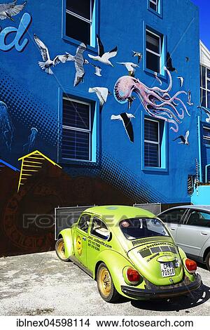 Picture - Green VW Beetle in front of painted house facade, Muizenberg, Cape Town, Western Cape, South Africa, Africa. Fotosearch