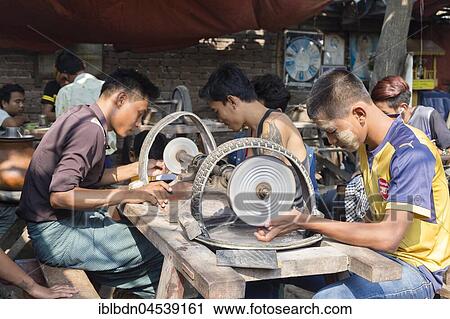 Stock Image - Grinding jade stones on a machine, Bogyoke Aung San Jade Market, Mandalay, Myanmar, Asia. Fotosearch