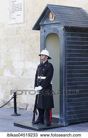 Stock Image - Guard with white helmet in front of the Presidential Palace, former Grand Palace, Valletta, Malta, Europe. Fotosearch