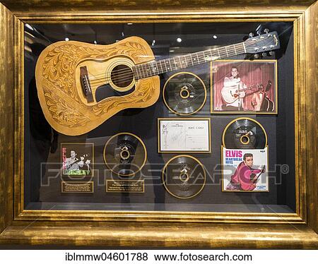 Stock Photo - Guitar and records from Elvis Presley in a showcase, Harrods Shopping Centre, London, England, Great Britain. Fotosearch