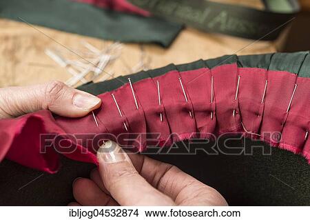 Hands folding and fastening silk ribbon using pins, inner lining of a wool felt hat, hatmaker workshop, Bad Aussee, Styria, Austria, Europe View Large Photo Image Picture - Hands folding and fastening silk ribbon using pins, inner lining of a wool felt hat, hatmaker workshop, Bad Aussee, Styria, Austria, Europe. Fotosearch
