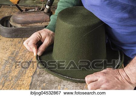 Stock Photo - Hands holding cord on dry wool felt hat with shaped edge, hatmaker workshop, Bad Aussee, Styria, Austria, Europe. Fotosearch