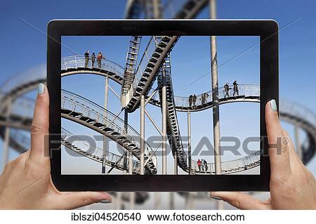 Hands holding tablet pc, with photo of Tiger and Turtle, Duisburg, Ruhr area, North Rhine-Westphalia, Germany, Europe View Large Photo Image Stock Image - Hands holding tablet pc, with photo of Tiger and Turtle, Duisburg, Ruhr area, North Rhine-Westphalia, Germany, Europe. Fotosearch