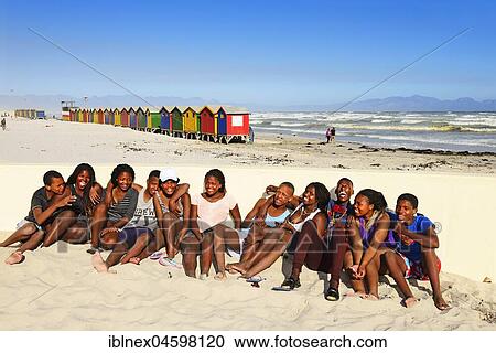 Happy black teenagers on the beach, colorful beach cottages, Muizenberg, False Bay, Western Cape, South Africa, Africa View Large Photo Image Stock Image - Happy black teenagers on the beach, colorful beach cottages, Muizenberg, False Bay, Western Cape, South Africa, Africa. Fotosearch