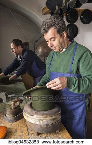 Stock Photo - Hatter holding dry wool felt hat in an edge mold, hatmaker workshop, Bad Aussee, Styria, Austria, Europe. Fotosearch