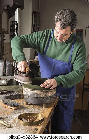 Picture - Hatter ironing dry wool felt hat over edge mold, hatmaker workshop, Bad Aussee, Styria, Austria, Europe. Fotosearch