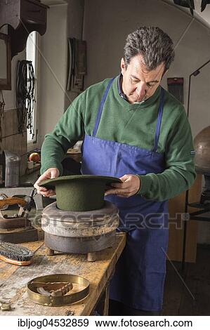 Stock Photo - Hatter pushing dry wool felt hat into edge mold, hatmaker workshop, Bad Aussee, Styria, Austria, Europe. Fotosearch