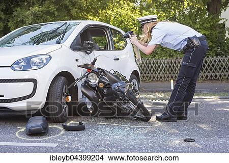 Heavy road accident, Simson scooter crashing in car, policewoman recording accident, Germany, Europe View Large Photo Image Picture - Heavy road accident, Simson scooter crashing in car, policewoman recording accident, Germany, Europe. Fotosearch