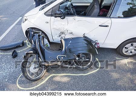 Stock Photography - Heavy road accident, Simson scooter crashing in car, policewoman at the accident, Germany, Europe. Fotosearch