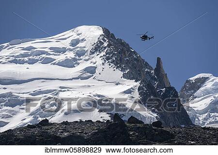 Stock Photo - Helicopter flies over glaciers, alpine rescue, mountain rescue, Mont Blanc massif, Chamonix, Haute-Savoie, France, Europe. Fotosearch