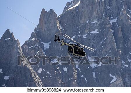 Helicopter in front of mountains, behind Aiguille du Midi, Alpine rescue, mountain rescue, Mont Blanc massif, Chamonix, Haute-Savoie, France, Europe View Large Photo Image Picture - Helicopter in front of mountains, behind Aiguille du Midi, Alpine rescue, mountain rescue, Mont Blanc massif, Chamonix, Haute-Savoie, France, Europe. Fotosearch