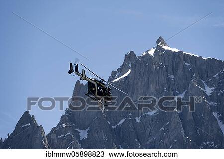 Helicopter in front of the summit of the Aiguille du Midi, Alpine rescue, mountain rescue, Mont Blanc massif, Chamonix, Haute-Savoie, France, Europe View Large Photo Image Stock Image - Helicopter in front of the summit of the Aiguille du Midi, Alpine rescue, mountain rescue, Mont Blanc massif, Chamonix, Haute-Savoie, France, Europe. Fotosearch