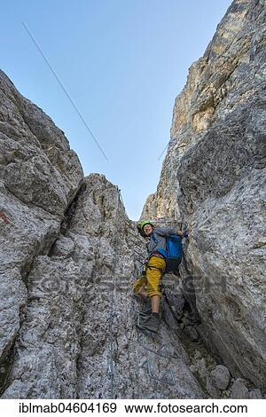 Hiker climbing in the Santner via ferrata, Rosengarten Group, Dolomites, South Tyrol, Trentino-Alto Adige, Italy, Europe View Large Photo Image Stock Photo - Hiker climbing in the Santner via ferrata, Rosengarten Group, Dolomites, South Tyrol, Trentino-Alto Adige, Italy, Europe. Fotosearch