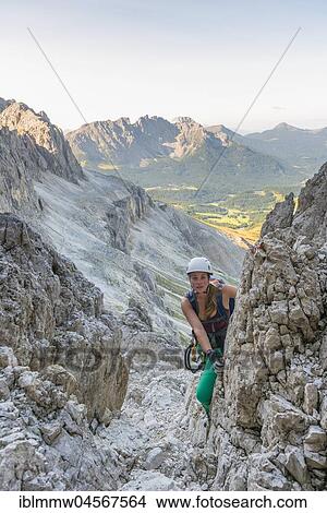 Hiker climbs the Santner via ferrata, view of Latemar Group, Rosengarten Group, Dolomites, South Tyrol, Trentino-Alto Adige, Italy, Europe View Large Photo Image Picture - Hiker climbs the Santner via ferrata, view of Latemar Group, Rosengarten Group, Dolomites, South Tyrol, Trentino-Alto Adige, Italy, Europe. Fotosearch