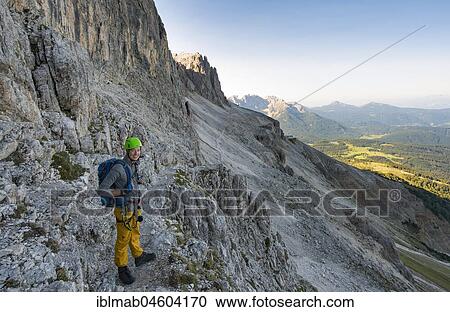 Stock Image - Hiker on the way to Santner via ferrata, Rosengarten Group, Dolomites, South Tyrol, Trentino-Alto Adige, Italy, Europe. Fotosearch