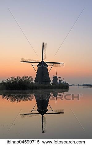 Stock Photography - Historical windmills at dawn, UNESCO World Heritage Site, Kinderdijk, province of South Holland, Netherlands. Fotosearch