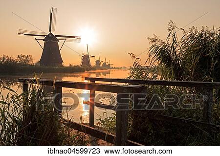 Historical windmills at sunrise, UNESCO World Heritage Site, Kinderdijk, province of South Holland, Netherlands View Large Photo Image Stock Image - Historical windmills at sunrise, UNESCO World Heritage Site, Kinderdijk, province of South Holland, Netherlands. Fotosearch