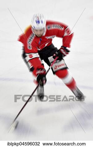 Stock Image - Hockey player in motion, action, blurred. Fotosearch