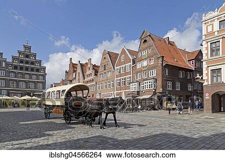 Horse-drawn carriage in front of brick houses, Am Sande, Lüneburg, Lower Saxony, Germany, Europe View Large Photo Image Picture - Horse-drawn carriage in front of brick houses, Am Sande, Lüneburg, Lower Saxony, Germany, Europe. Fotosearch