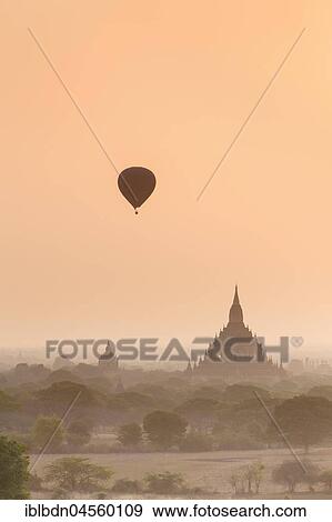 Hot air balloon over Bagan temples at sunrise, Bagan, Division Mandalay, Myanmar, Asia View Large Photo Image Stock Photo - Hot air balloon over Bagan temples at sunrise, Bagan, Division Mandalay, Myanmar, Asia. Fotosearch